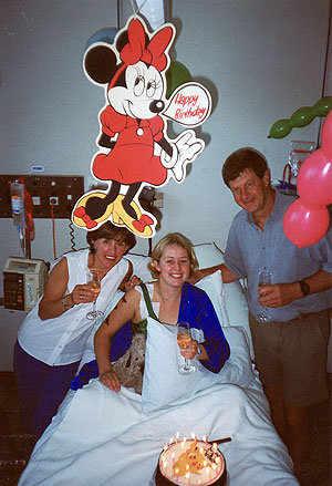 Caroline celebrating her 21st birthday with her parents.